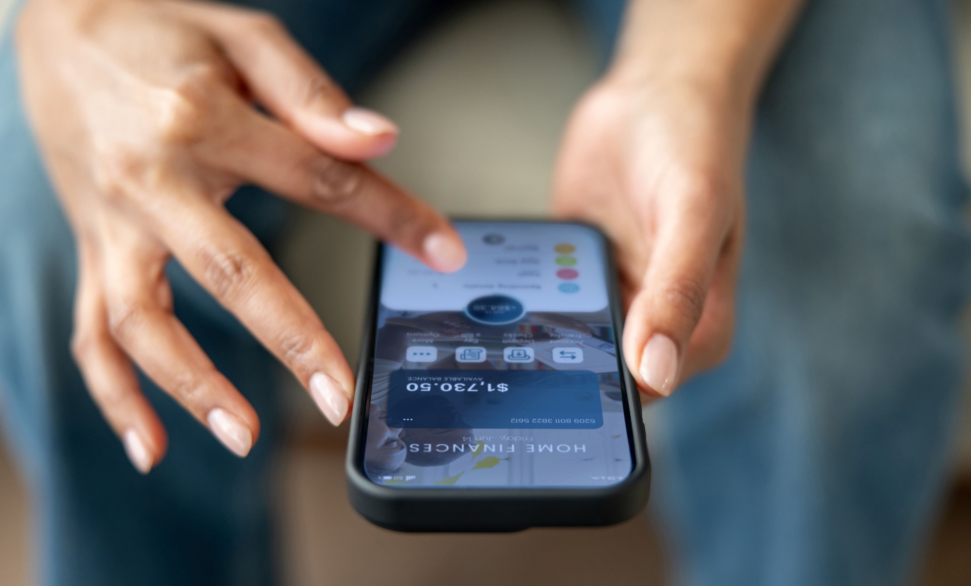 Woman organizing her home finances using a mobile app on her cell phone